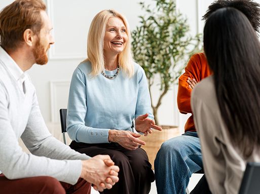 Four people talking in a community health group