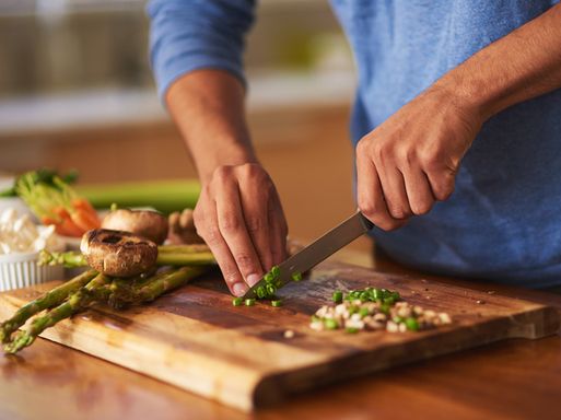 A man chopping ingredients for a healthy meal