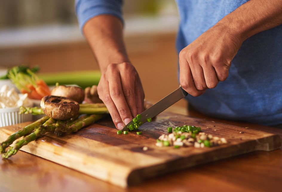 A man chopping ingredients for a healthy meal