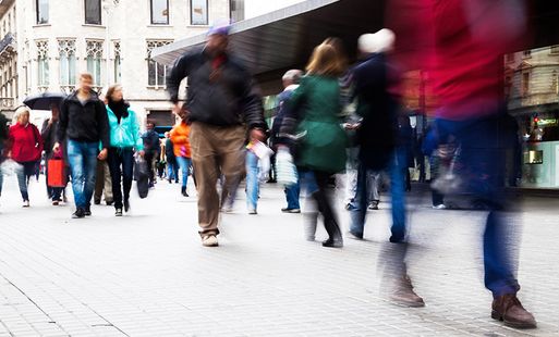 A blurry shot of people walking down a high street.