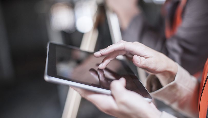Female pest control surveyor using an ipad