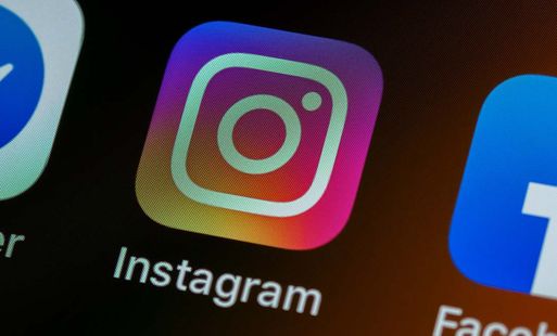 A close-up shot of a phone screen showing the Instagram logo.